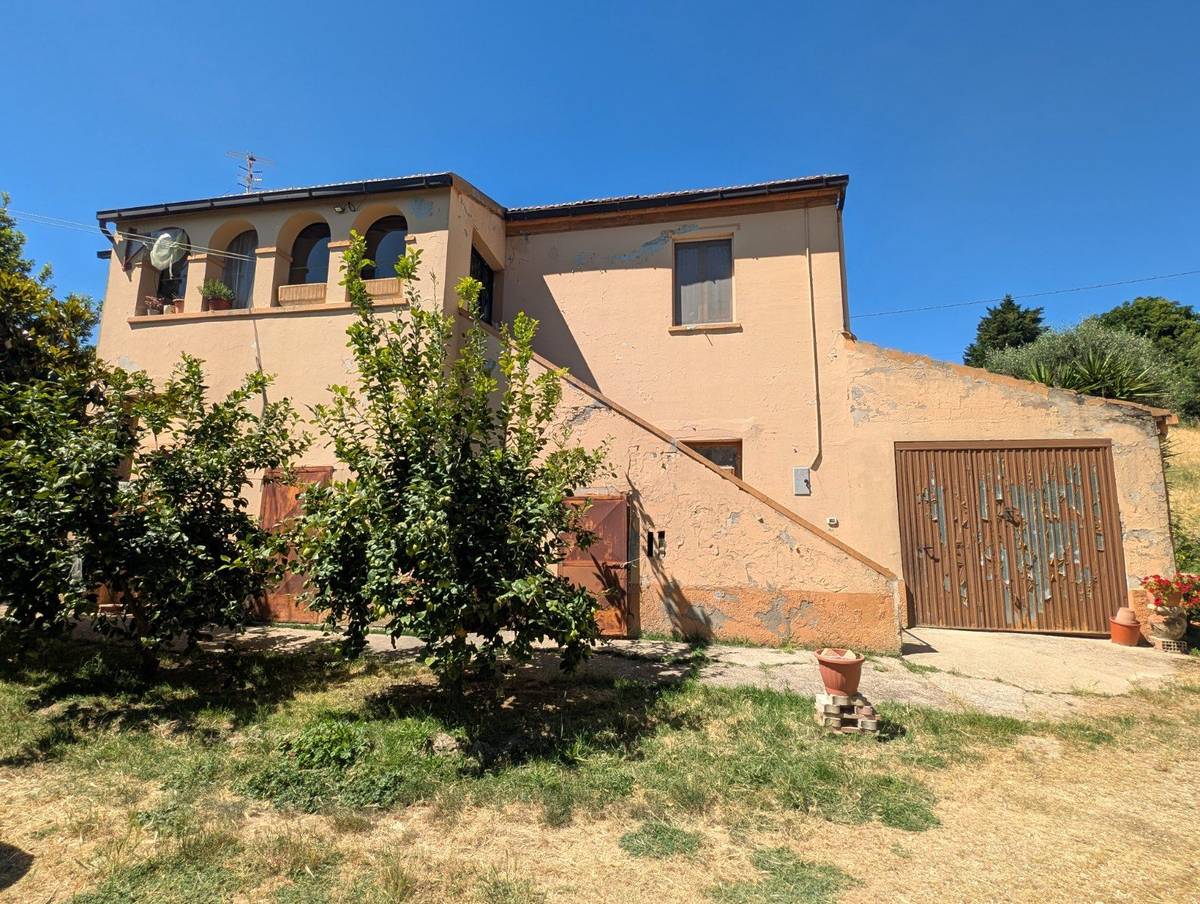 The 1950s stone farmhouse at Contrada Cona, Atri, in summer 2026